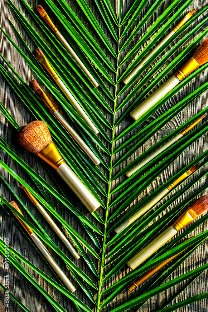 make-up set with brushes on rustic table background top view mock up