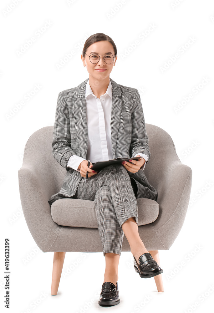 Portrait of female psychologist sitting in armchair on white background