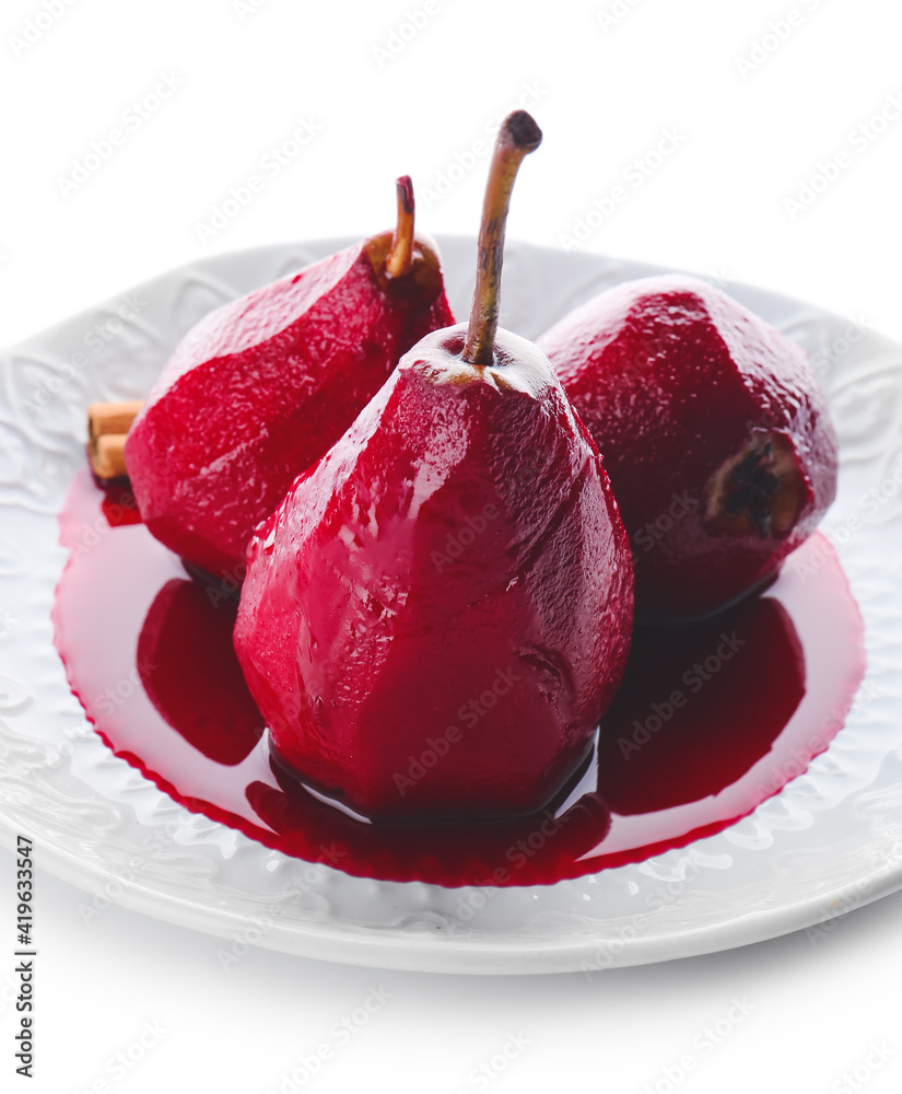 Plate of tasty poached pears in wine sauce on white background