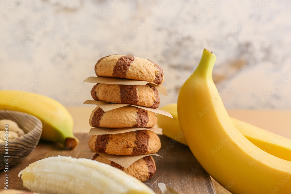 Board with tasty cookies and bananas, closeup