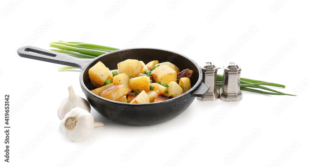 Frying pan of tasty potato with garlic on white background