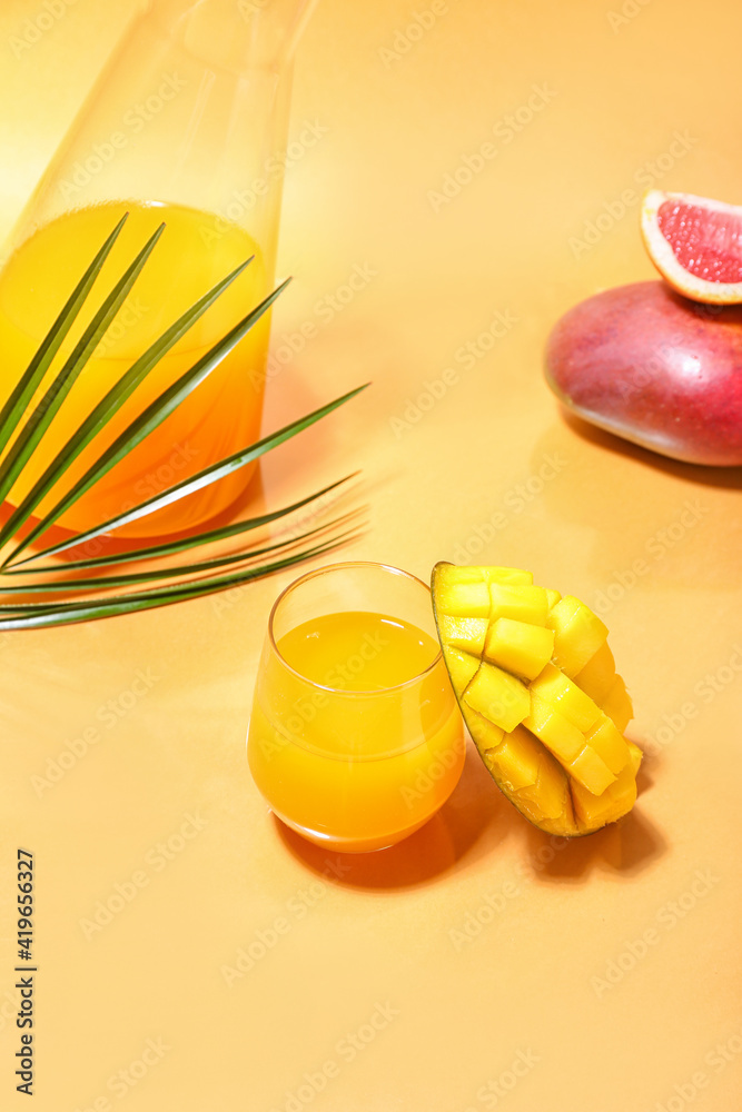 Glass of tasty mango margarita on color background