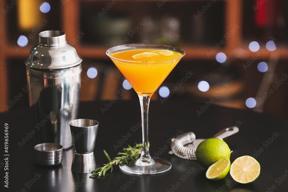 Glass of tasty mango margarita on table in bar