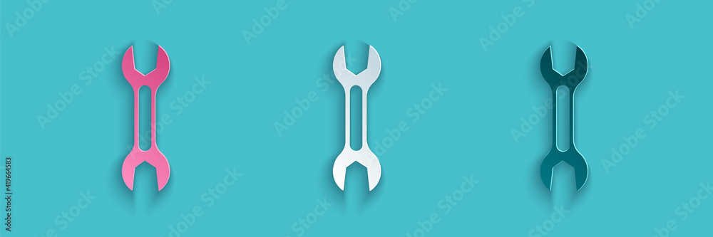 Paper cut Wrench spanner icon isolated on blue background. Paper art style. Vector.