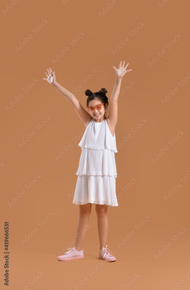 Happy little girl on color background