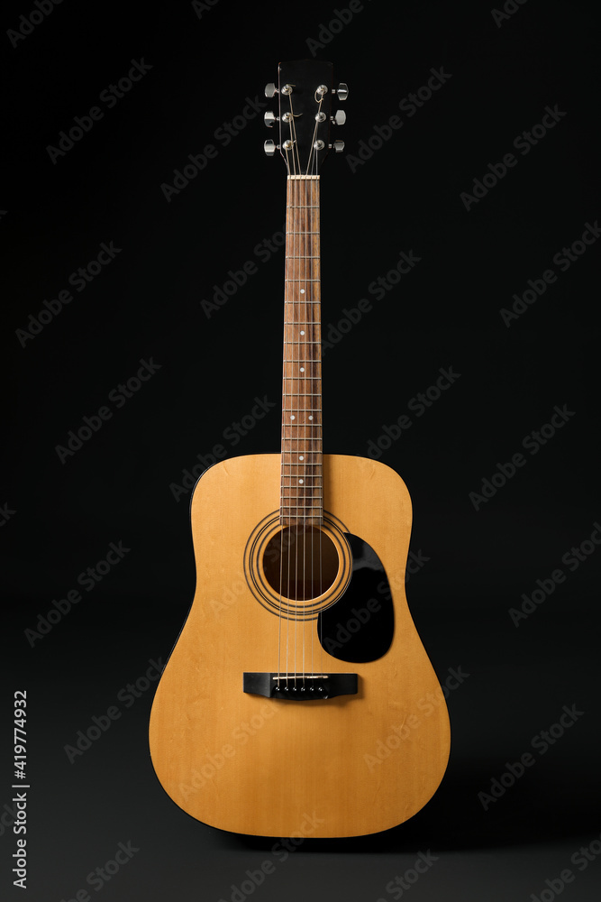 Acoustic guitar on dark background