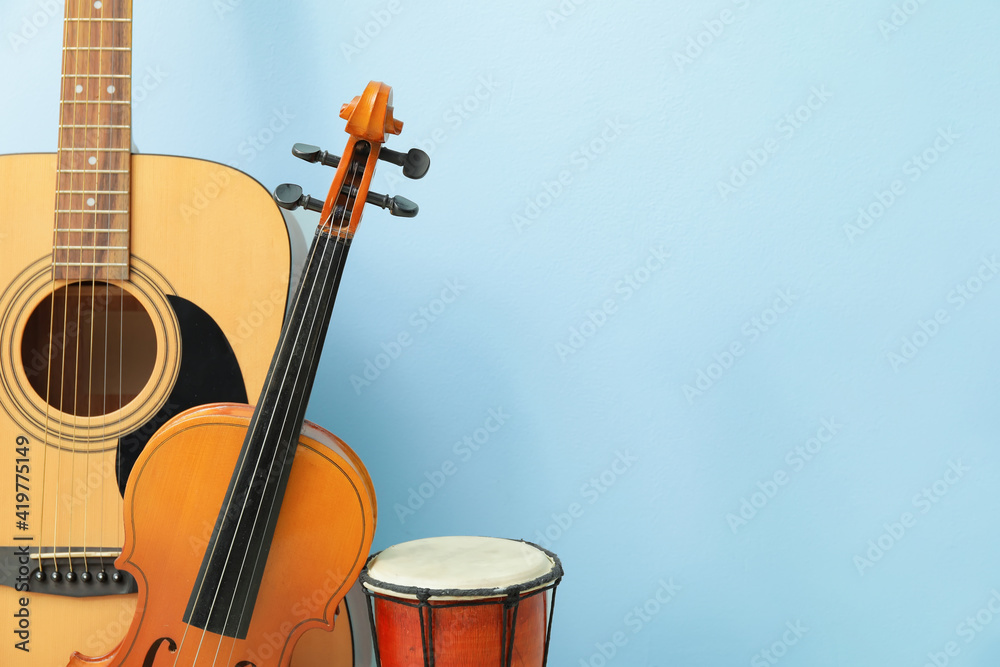 Different musical instruments on color background, closeup