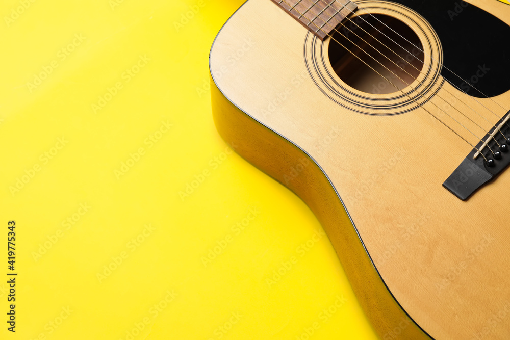 Acoustic guitar on color background, closeup