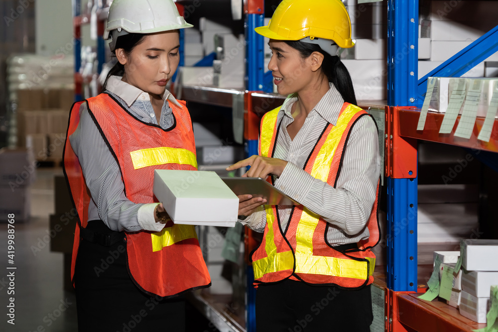 Female warehouse worker working at the storehouse . Logistics , supply chain and warehouse business 