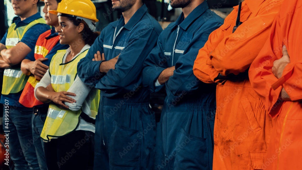 Skillful worker stand together showing teamwork in the factory . Industrial people and manufacturing