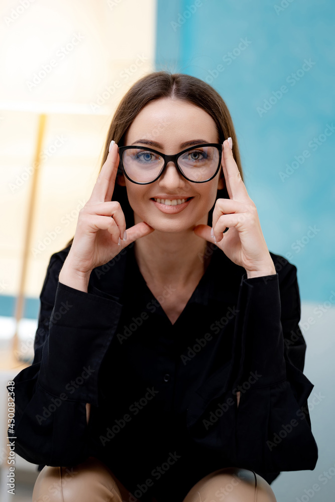 Pretty young woman in glasses posing for camera. Beautiful attractive girl with glasses.