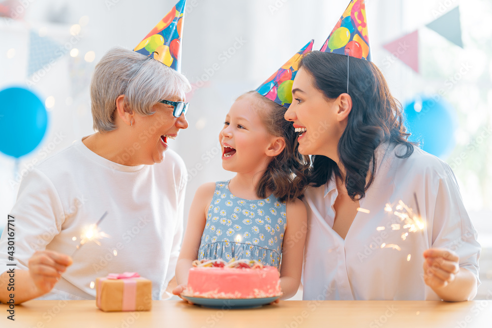 Grandmother, mother and daughter are celebrating birthday.