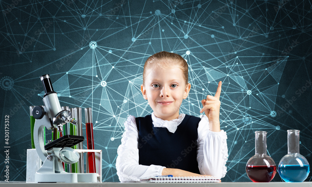 Little girl scientist sitting at desk