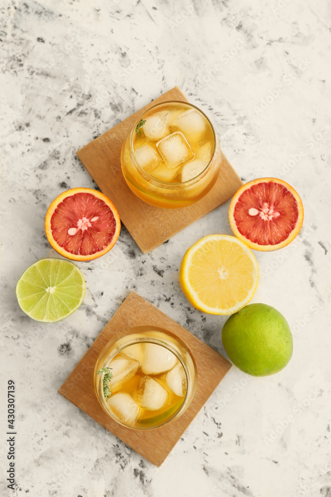 Glasses of cold green tea and fruits on light background