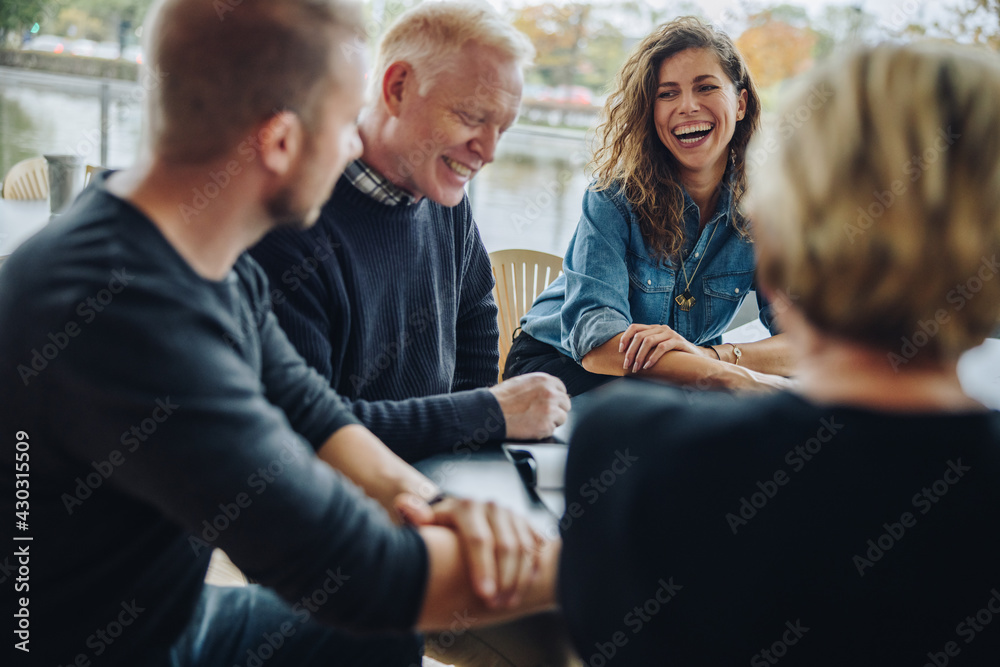 Business team discussing over an agreement in meeting