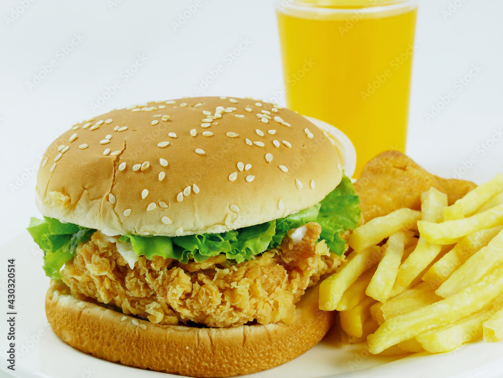 Hamburger with a chicken leg, french fries and orange juice, healthy and nutritious breakfast