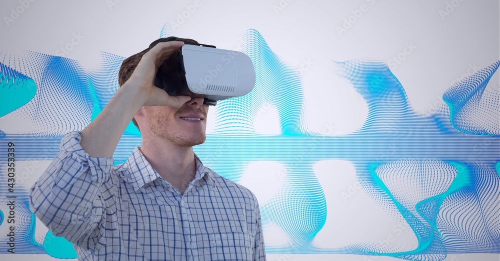 Composition of smiling man wearing vr headset over blue light trails