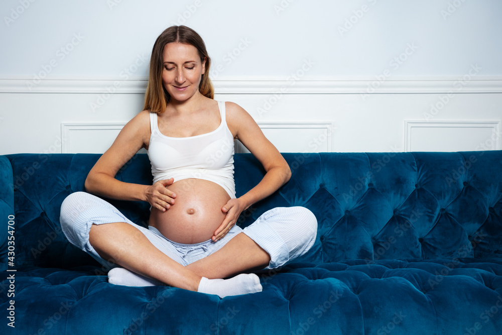 Portrait of pregnant woman sit on the sofa