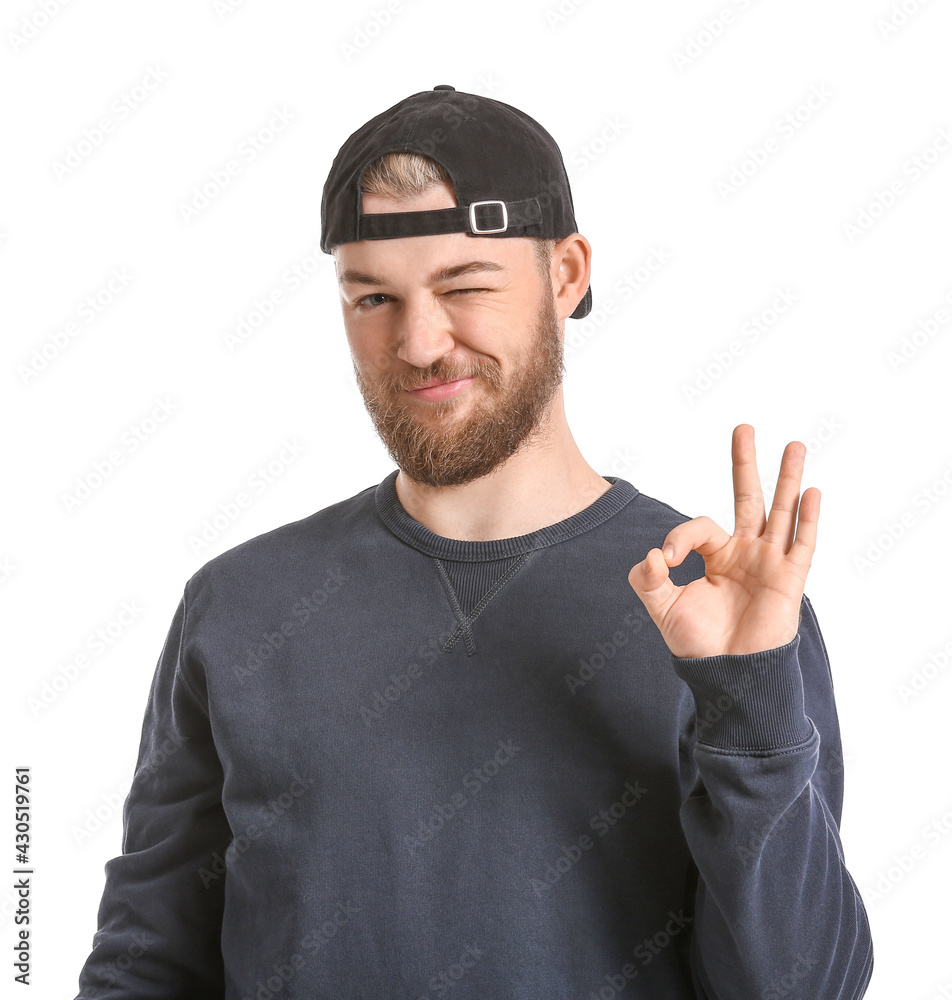 Young man showing OK on white background