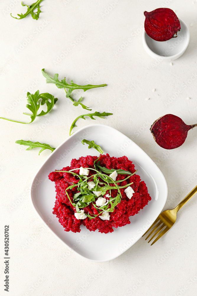 Plate with tasty beet risotto on light background