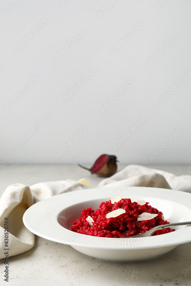 Plate with tasty beet risotto on light background