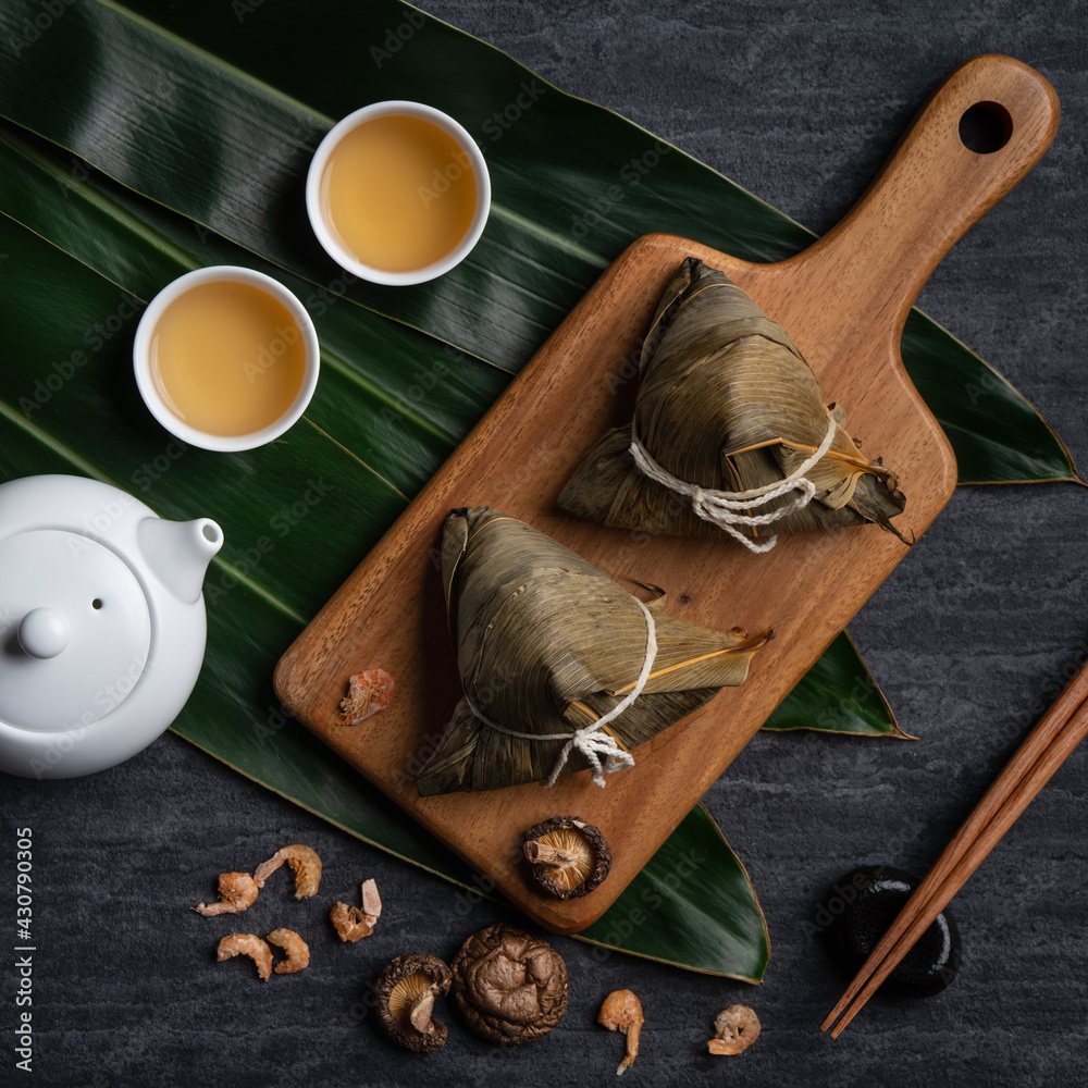 Zongzi. Rice dumpling top view for Dragon Boat Festival over dark black background.