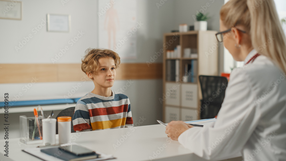 Female Family Doctor Talking with Healthy Young Handsome Teenage Boy During Consultation in a Health