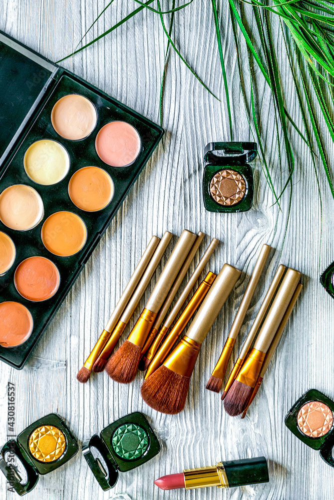 cosmetic set with eye shadow on woman table background top view