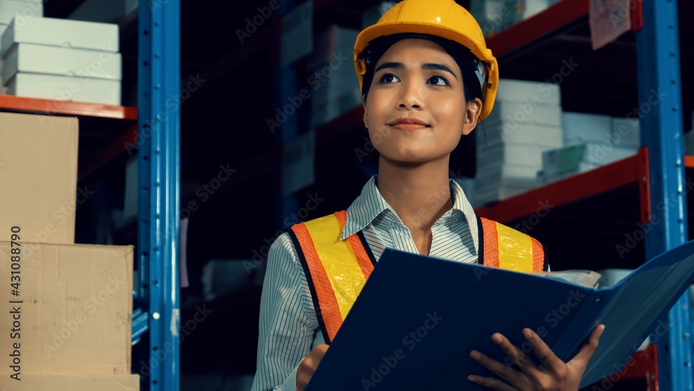 Female warehouse worker working at the storehouse . Logistics , supply chain and warehouse business 