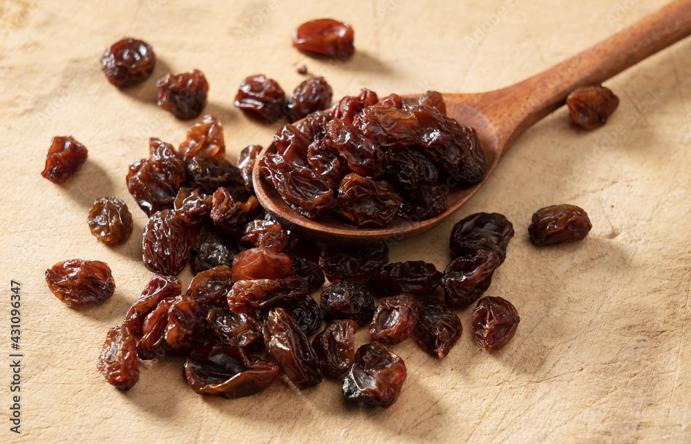 Raisins on an old wooden background.