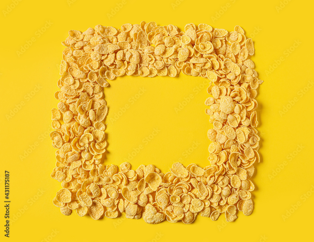 Frame made of tasty cornflakes on color background