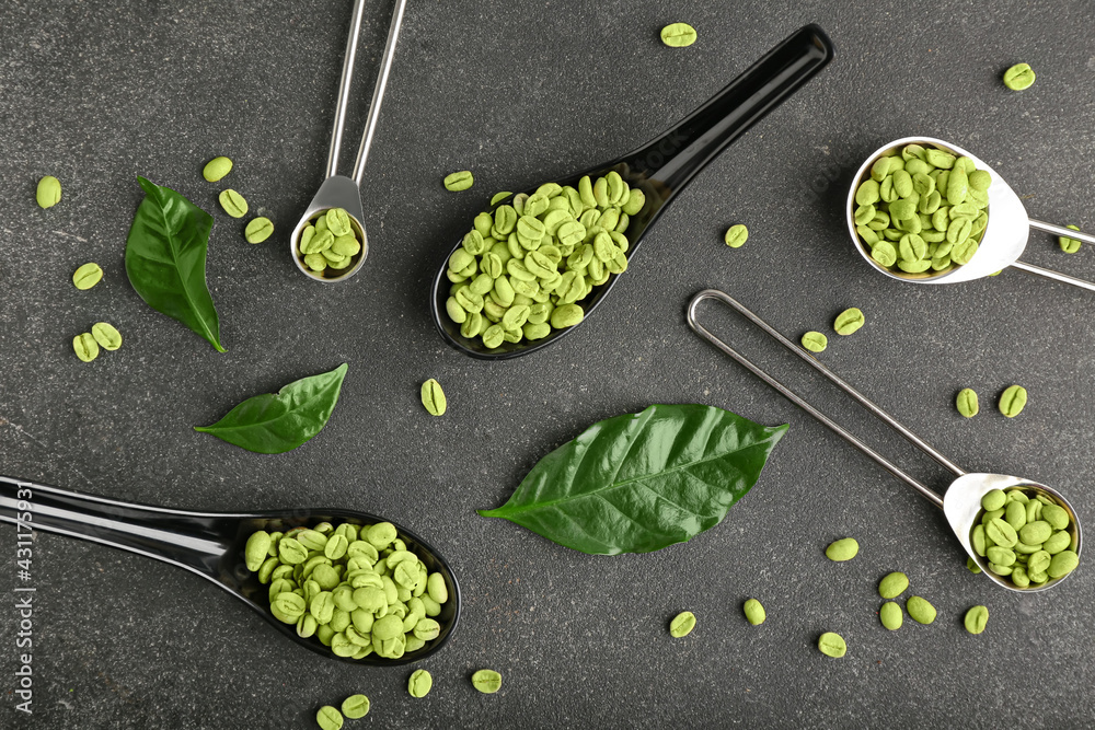 Composition with green coffee beans on dark background