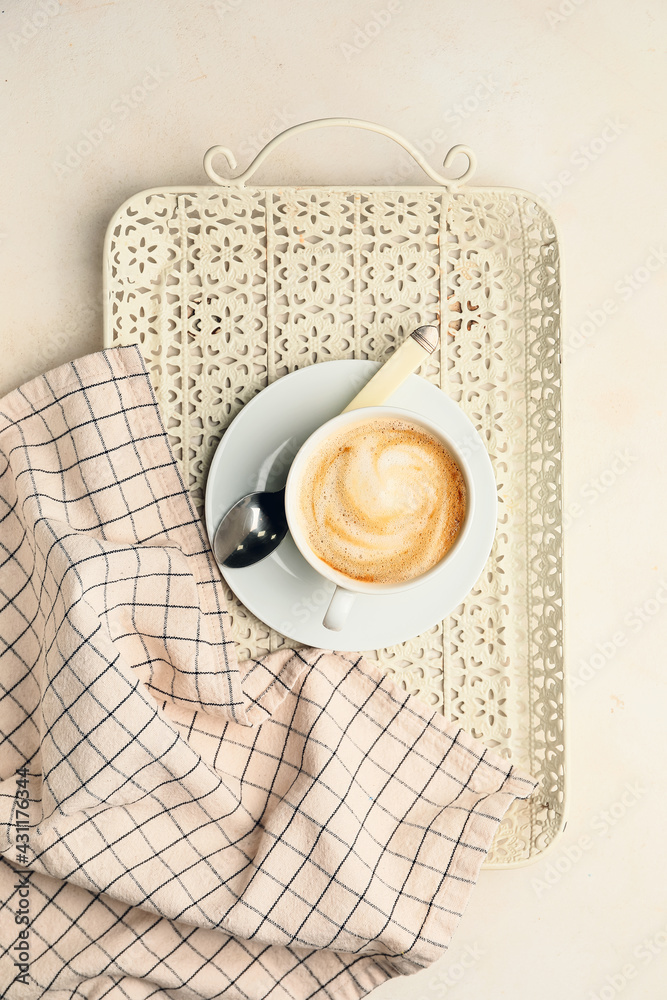 Cup of hot cappuccino on light background