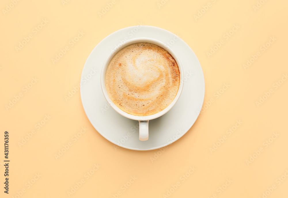 Cup of hot cappuccino on color background