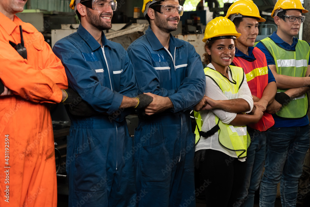 Skillful worker stand together showing teamwork in the factory . Industrial people and manufacturing