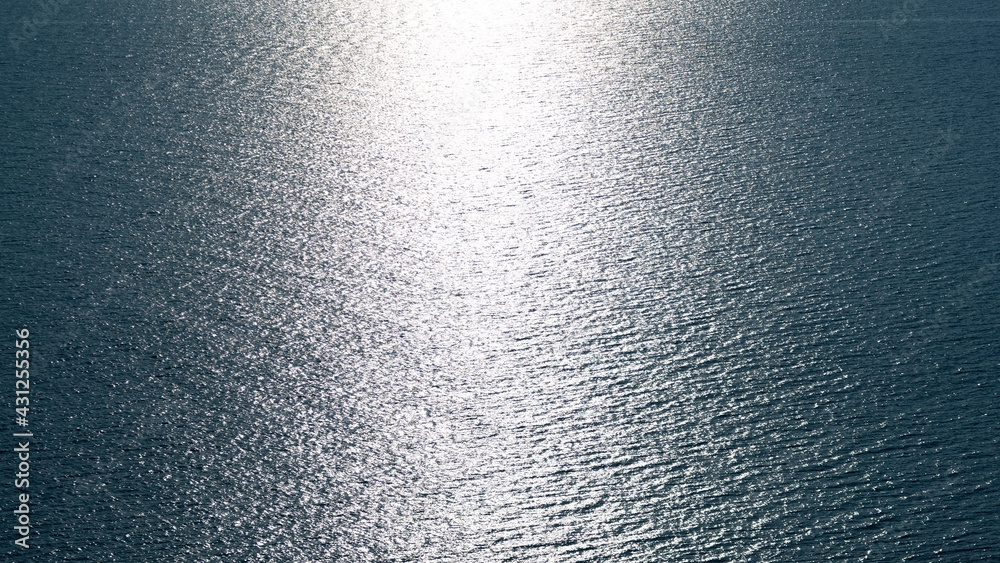 Aerial view Texture of Blue sea surface with small waves in the sea and Beautiful light sunset or su