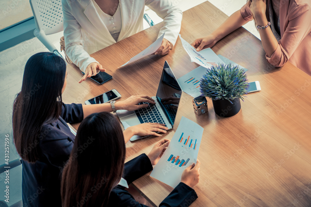 Businesswoman in group meeting discussion with other businesswomen colleagues in modern workplace of