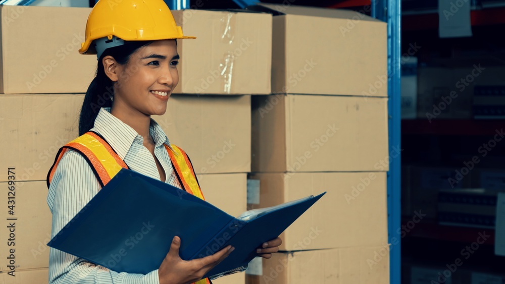 Female warehouse worker working at the storehouse . Logistics , supply chain and warehouse business 