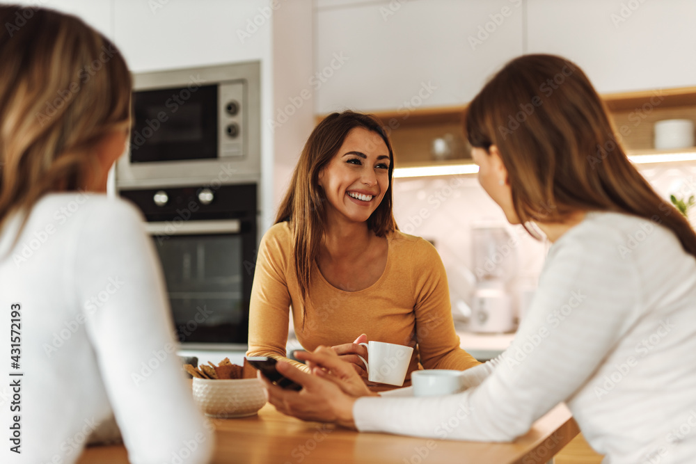 Smiling faces, kitchen in the background.