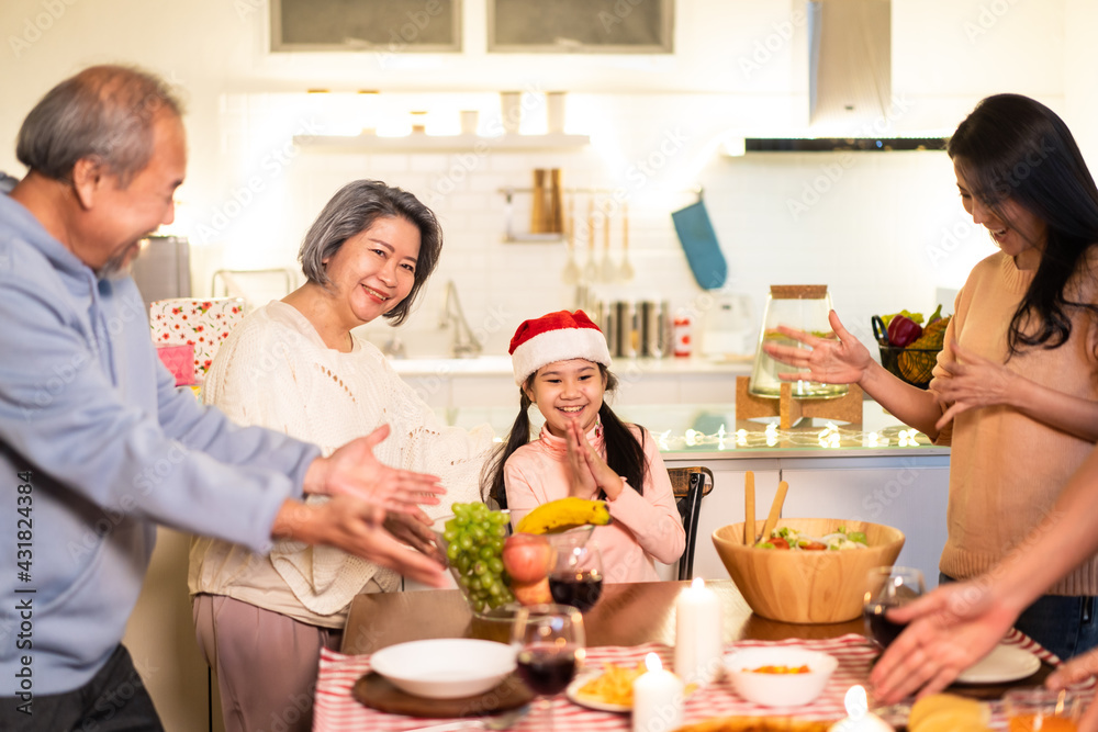 Asian big family sing a song while preparing foods for Christmas party