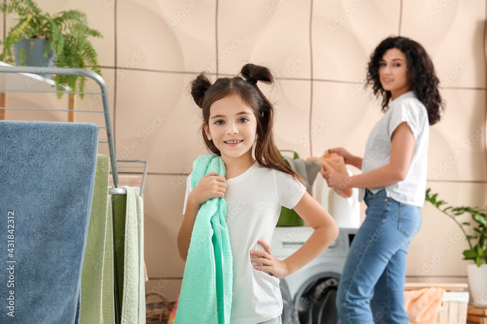 Mother and daughter doing laundry at home