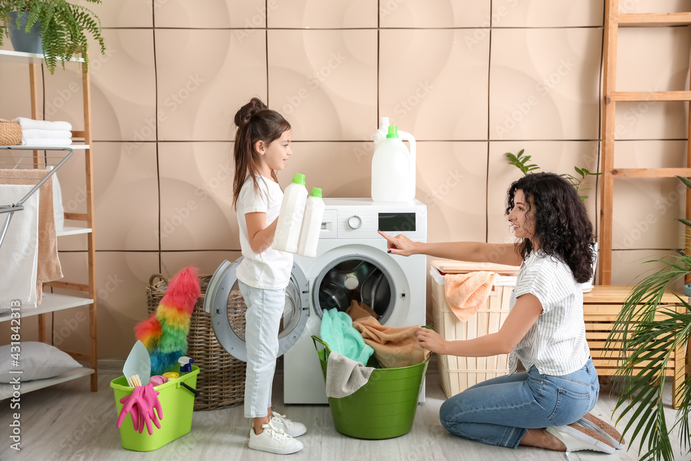 Mother and daughter doing laundry at home