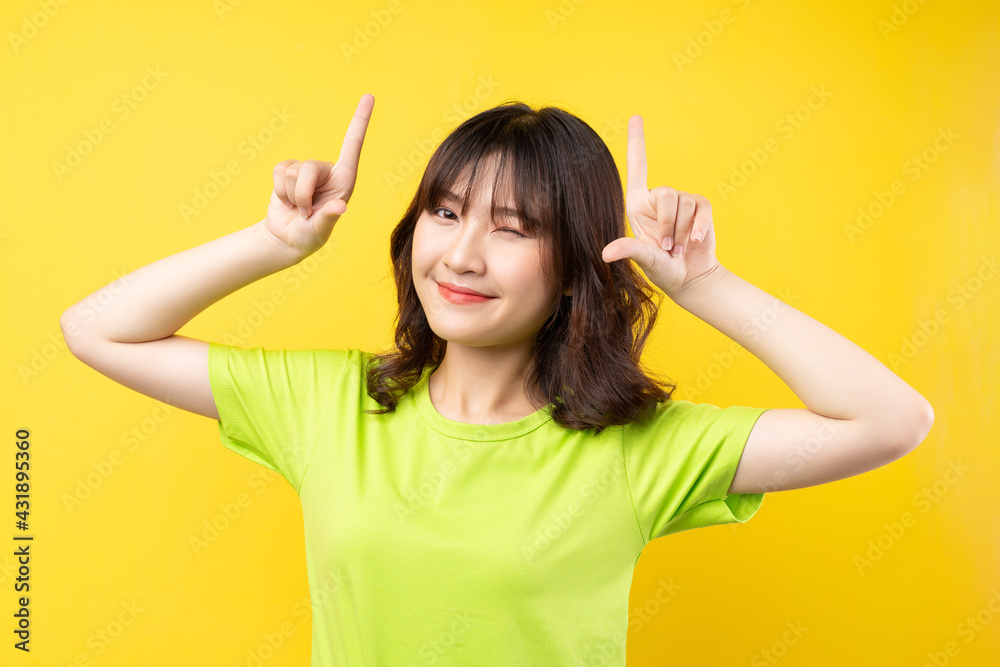 Young Asian girl with expressions and gestures on background