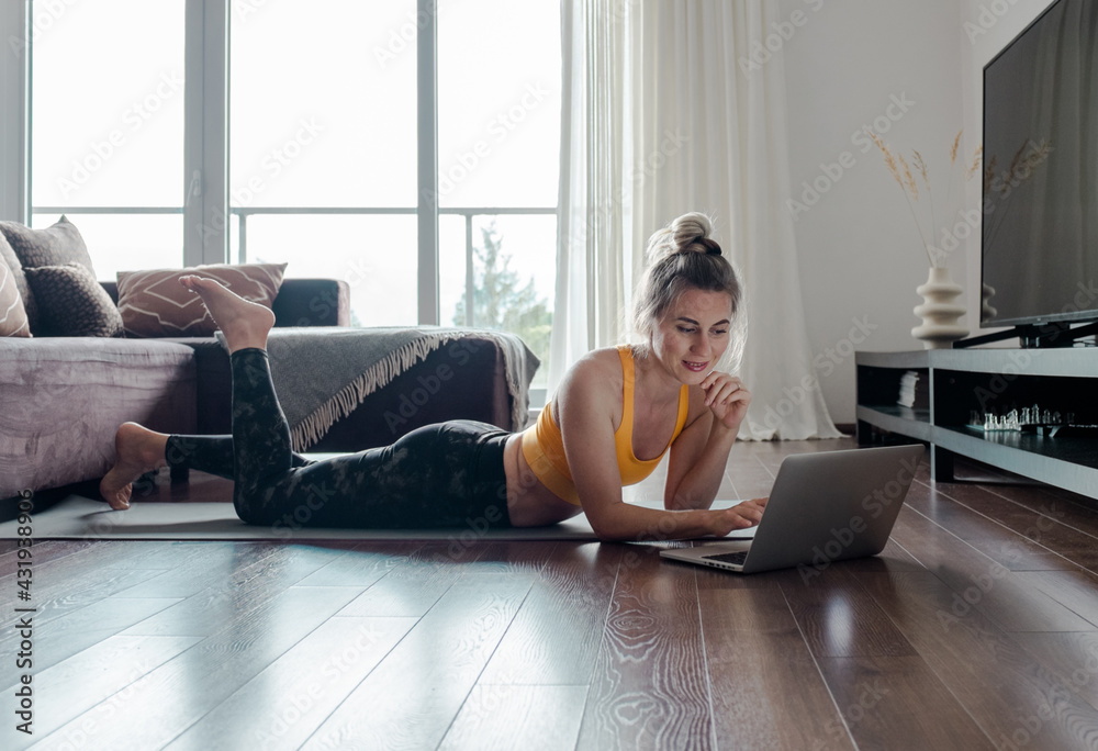 Woman doing online yoga at home. Female trener teaches asana in video conference. Health care, authe