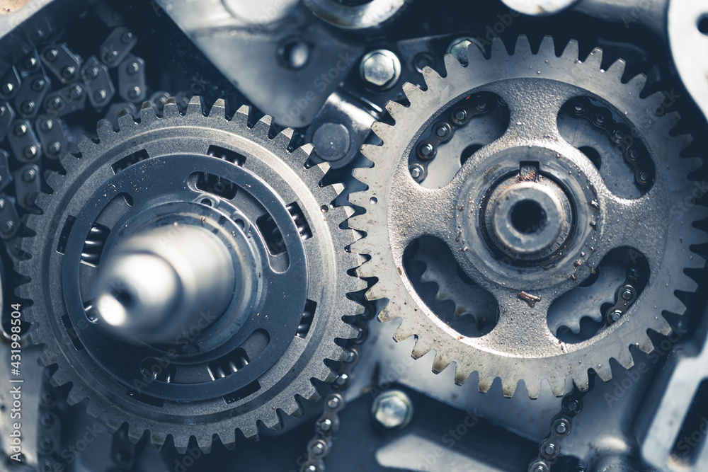 atv engine gears with oil traces and dirt, disassembled for repairing and maintenance