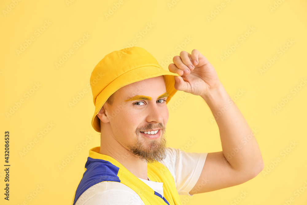 Stylish young man on yellow background