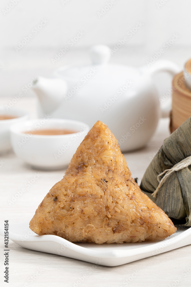 Zongzi. Rice dumpling for Dragon Boat Festival on bright wooden table background.