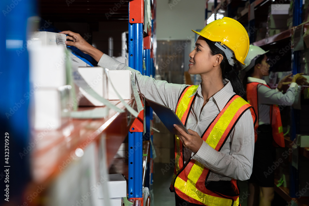 Female warehouse worker working at the storehouse . Logistics , supply chain and warehouse business 