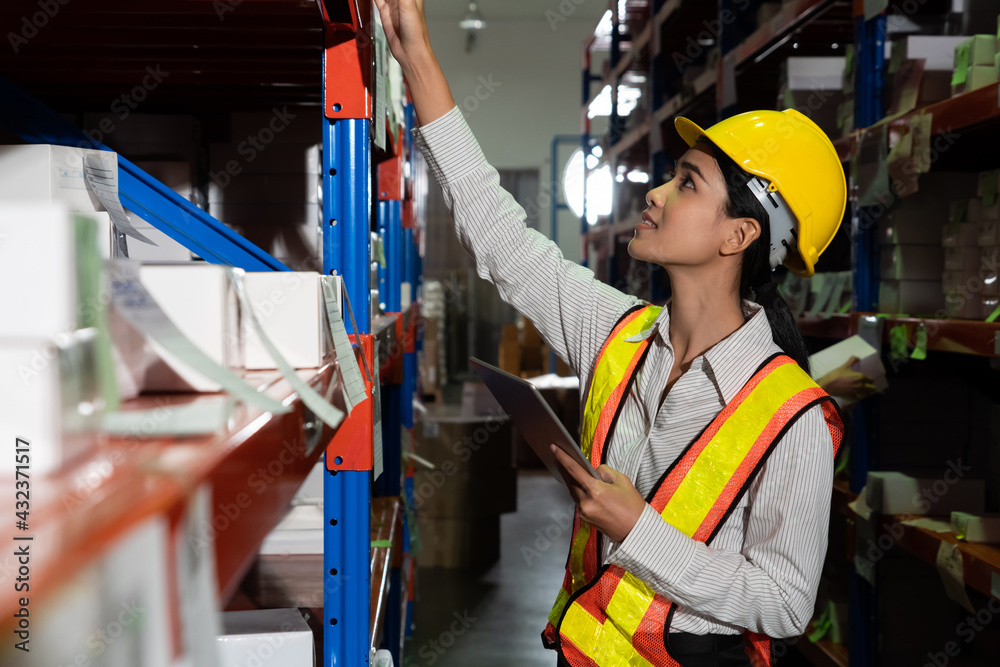 Female warehouse worker working at the storehouse . Logistics , supply chain and warehouse business 