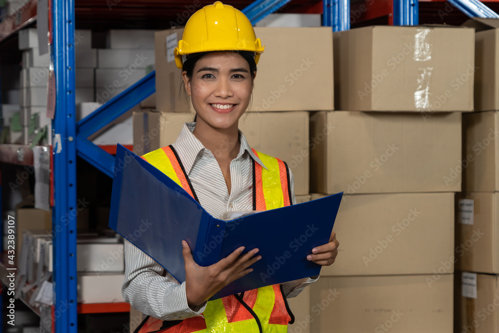 Female warehouse worker working at the storehouse . Logistics , supply chain and warehouse business 